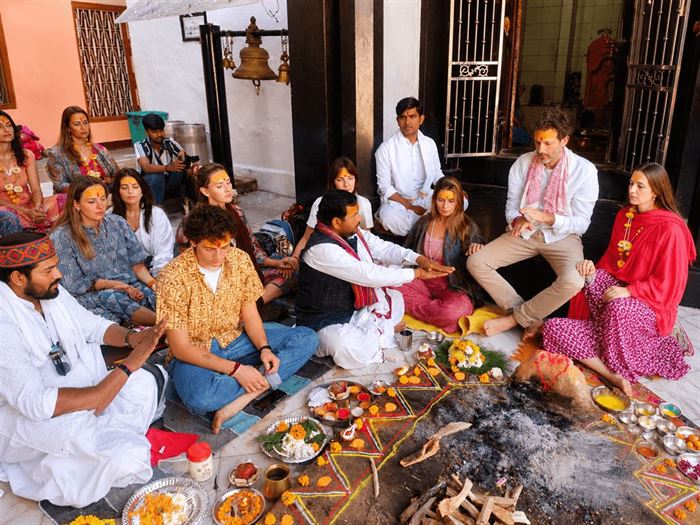 International devotees seated for puja at the temple