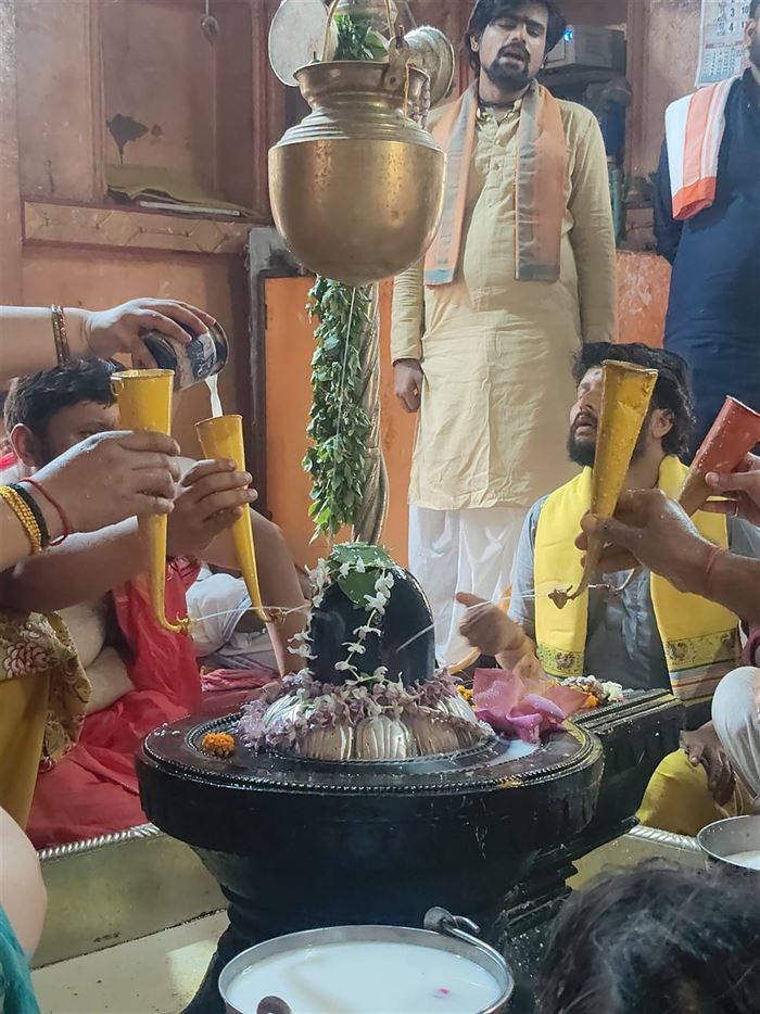 Devotees offering milk abhishek on the Shivling